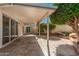 Covered patio with tile floor, views of the yard, and sliding glass doors to the home at 10419 W Loma Blanca Dr, Sun City, AZ 85351