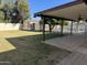 A covered patio overlooks a spacious backyard with a pool and storage shed at 10633 N 46Th Ave, Glendale, AZ 85304