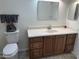 Bathroom featuring wood cabinets, a marble countertop, and modern fixtures at 10633 N 46Th Ave, Glendale, AZ 85304