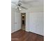 Neutral bedroom with a ceiling fan, closet, and adjacent bathroom access at 10633 N 46Th Ave, Glendale, AZ 85304