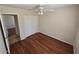 Bedroom with wood-look flooring, closet, and a ceiling fan at 10633 N 46Th Ave, Glendale, AZ 85304