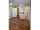 Bedroom with wood floors, ceiling fan, and en suite bathroom at 10633 N 46Th Ave, Glendale, AZ 85304
