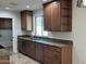 Well-equipped kitchen featuring granite countertops, wood cabinets, stainless steel appliances, and tile flooring at 10633 N 46Th Ave, Glendale, AZ 85304