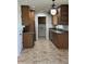 Well-equipped kitchen featuring granite countertops, wood cabinets, stainless steel appliances, and tile flooring at 10633 N 46Th Ave, Glendale, AZ 85304