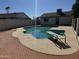 A backyard pool with diving board is surrounded by a brick and concrete patio at 10633 N 46Th Ave, Glendale, AZ 85304