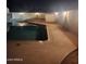 Night view of backyard pool featuring in-ground lighting and a concrete perimeter at 10633 N 46Th Ave, Glendale, AZ 85304