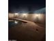 Night view of backyard pool featuring in-ground lighting and a concrete perimeter at 10633 N 46Th Ave, Glendale, AZ 85304