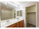 Bright bathroom features double sinks, wood cabinets, and glass block enclosed shower at 1088 S Storment Ln, Gilbert, AZ 85296