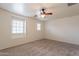 Bedroom boasts neutral walls, a ceiling fan, and a large window for natural light at 1088 S Storment Ln, Gilbert, AZ 85296