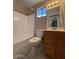 The bathroom features a white toilet, shower/tub, sink, and brown cabinets at 113 W Bluefield Ave, Phoenix, AZ 85023