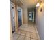 A hallway with tiled floors and doors leading to other rooms at 113 W Bluefield Ave, Phoenix, AZ 85023