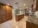 Spacious kitchen with granite countertops, stainless steel appliances, ample cabinet space, and tiled flooring at 113 W Bluefield Ave, Phoenix, AZ 85023