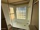 Glass-enclosed shower features custom tile, built in bench and shower head at 113 W Bluefield Ave, Phoenix, AZ 85023