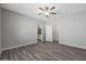 This bedroom features a ceiling fan, gray walls, and an opening to the bathroom at 11472 W Arron Dr, Youngtown, AZ 85363