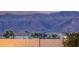 Mountain views over a block wall and neighboring houses with a landscaped backyard at 11674 E Yeager Cyn, Gold Canyon, AZ 85118