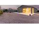 Gravel backyard has covered patio with tile flooring and rock border around a fire pit at 11674 E Yeager Cyn, Gold Canyon, AZ 85118