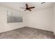 Carpeted bedroom features a ceiling fan, window with blinds, and neutral walls at 11674 E Yeager Cyn, Gold Canyon, AZ 85118