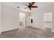 Spacious bedroom with plush carpet flooring, a ceiling fan, and ensuite bathroom entrance at 11674 E Yeager Cyn, Gold Canyon, AZ 85118