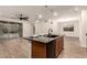 Stylish kitchen island with seating, stainless steel sink, and an open view to the living area at 11674 E Yeager Cyn, Gold Canyon, AZ 85118