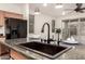 Kitchen island features a modern sink, breakfast bar, and stainless steel appliances at 11674 E Yeager Cyn, Gold Canyon, AZ 85118