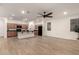 Open-concept living space showcasing wood flooring, a ceiling fan, and seamless flow into the kitchen at 11674 E Yeager Cyn, Gold Canyon, AZ 85118