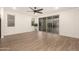 Bright living room features wood floors, a ceiling fan, and sliding glass doors to the backyard at 11674 E Yeager Cyn, Gold Canyon, AZ 85118