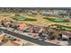 An elevated view of a neighborhood showcasing well-kept homes, desert landscaping and a nearby golf course at 13009 S 42Nd Pl, Phoenix, AZ 85044