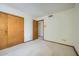 Bedroom with carpet, closet, and door, offering a simple and functional space at 13009 S 42Nd Pl, Phoenix, AZ 85044