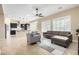 Open floor plan with living area flowing into the kitchen, showcasing tile flooring and modern design at 13145 W Whisper Rock Trl, Peoria, AZ 85383