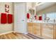 Bathroom featuring double sinks, wood cabinets, and a large mirror at 1369 E Prickly Pear Dr, Casa Grande, AZ 85122