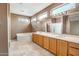 Large bathroom with a soaking tub, dual sinks, vanity, and natural light at 15109 W Camino Estrella Dr, Surprise, AZ 85374