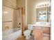 Bathroom with a shower-tub combo, single sink vanity, and tiled floors at 15109 W Camino Estrella Dr, Surprise, AZ 85374
