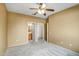 Bedroom featuring neutral walls, a ceiling fan, and access to the bathroom and closet at 15109 W Camino Estrella Dr, Surprise, AZ 85374
