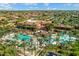 Resort-style community pool with palm trees, lounge chairs, and ample space for relaxation at 15109 W Camino Estrella Dr, Surprise, AZ 85374