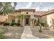 Stunning home featuring a desert landscape, palm trees, and a walkway to the front door at 15109 W Camino Estrella Dr, Surprise, AZ 85374