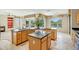 Well-equipped kitchen with an island, granite countertops, stainless appliances and a breakfast bar at 15109 W Camino Estrella Dr, Surprise, AZ 85374
