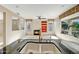 Open concept floorplan with a kitchen and a cozy living room with a fireplace at 15109 W Camino Estrella Dr, Surprise, AZ 85374