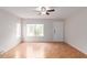 Bright living room with wood flooring, large windows, and a ceiling fan for comfortable living at 15550 N Frank Lloyd Wright Blvd # 1037, Scottsdale, AZ 85260