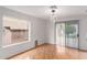 Bright living room featuring hardwood floors, sliding glass doors, and a contemporary light fixture at 15550 N Frank Lloyd Wright Blvd # 1037, Scottsdale, AZ 85260