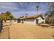 Rear exterior view with a desert landscape, block fence and a charming fire pit at 16414 N Dixie Mine Trl, Fountain Hills, AZ 85268