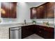 Kitchen featuring granite countertops, stainless steel dishwasher and dark wood cabinets at 16414 N Dixie Mine Trl, Fountain Hills, AZ 85268