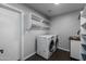 Practical laundry room equipped with modern appliances and ample storage shelving at 16414 N Dixie Mine Trl, Fountain Hills, AZ 85268