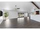 Expansive living room with a ceiling fan, gray tile flooring, and multiple sliding glass doors at 16414 N Dixie Mine Trl, Fountain Hills, AZ 85268