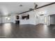 Open-concept living space with dark wood cabinets, ceiling fans, gray tile floors, and a front door at 16414 N Dixie Mine Trl, Fountain Hills, AZ 85268