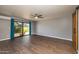 Bright living room features hardwood floors, ceiling fan and glass door leading to the outside at 16414 N Dixie Mine Trl, Fountain Hills, AZ 85268