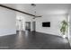 Spacious living room with gray tile floors, a decorative ceiling fan, and a textured accent wall at 16414 N Dixie Mine Trl, Fountain Hills, AZ 85268
