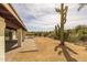 Wide angle of the covered patio, brick flooring, desert landscape, and outdoor cooking area at 16414 N Dixie Mine Trl, Fountain Hills, AZ 85268