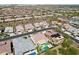 Aerial view of homes in the area; many with pools and green grass at 16949 W La Reata Ave, Goodyear, AZ 85395