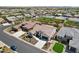 Stunning aerial view of a home, highlighting its tile roof, neutral exterior, and well-manicured front yard at 16949 W La Reata Ave, Goodyear, AZ 85395