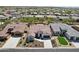 Stunning aerial view of a home, highlighting its tile roof, neutral exterior, and well-manicured front yard at 16949 W La Reata Ave, Goodyear, AZ 85395